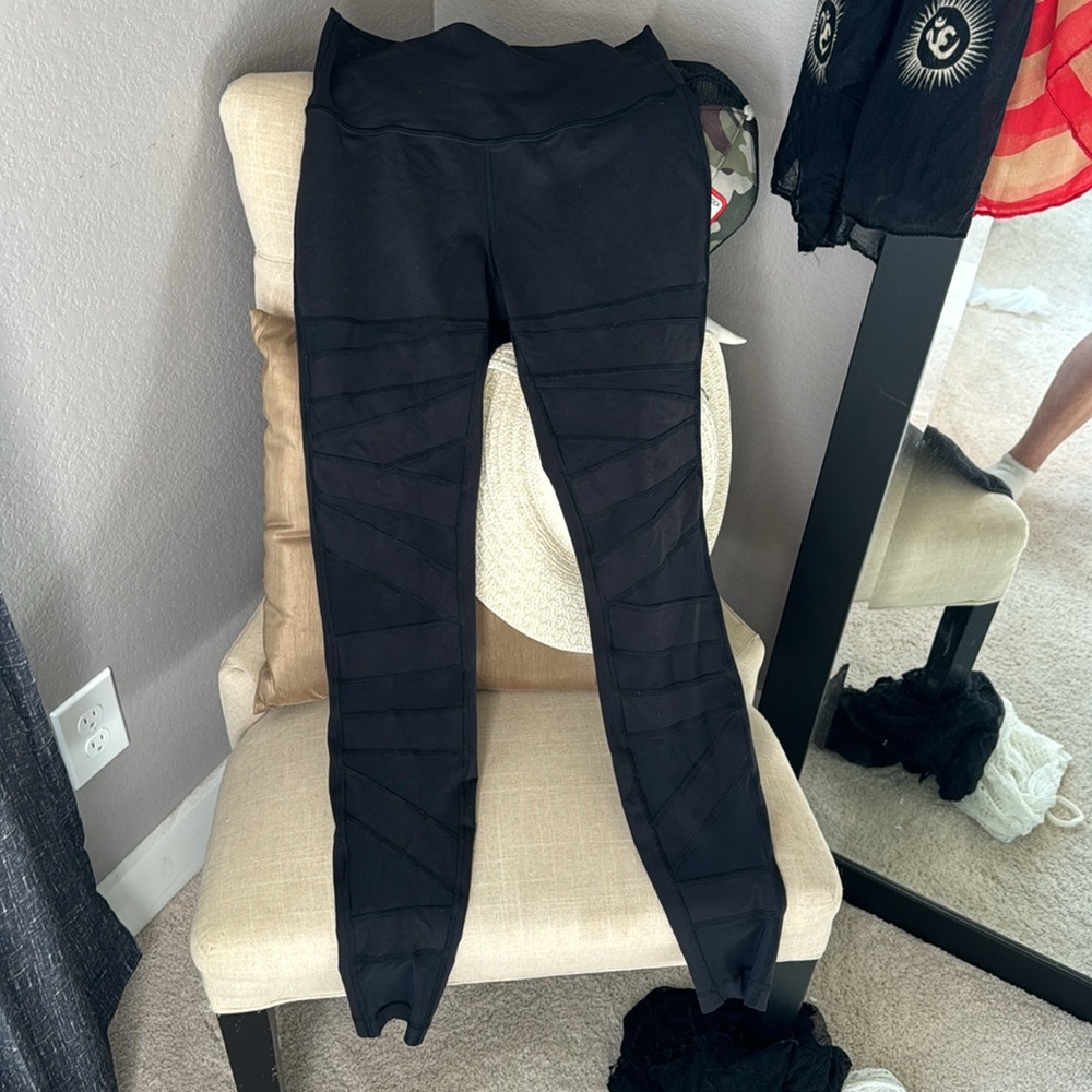 Lululemon black leggings with crisscrossed mesh tiger strips